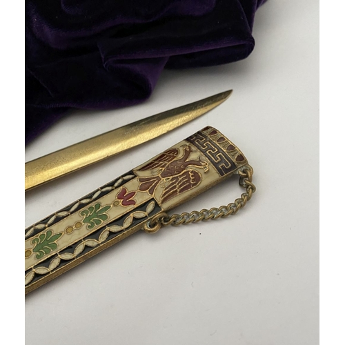 106 - A HIGHLY DECORATIVE BRASS ENAMELLED LETTER OPENER, the cover and handle with vibrantly coloured desi... 