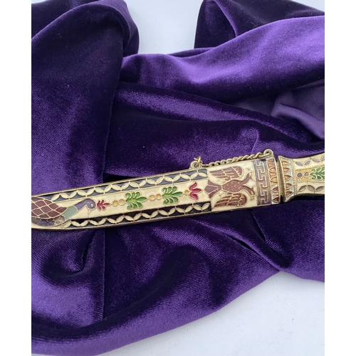 106 - A HIGHLY DECORATIVE BRASS ENAMELLED LETTER OPENER, the cover and handle with vibrantly coloured desi... 