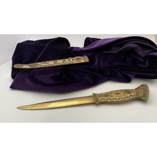 106 - A HIGHLY DECORATIVE BRASS ENAMELLED LETTER OPENER, the cover and handle with vibrantly coloured desi... 