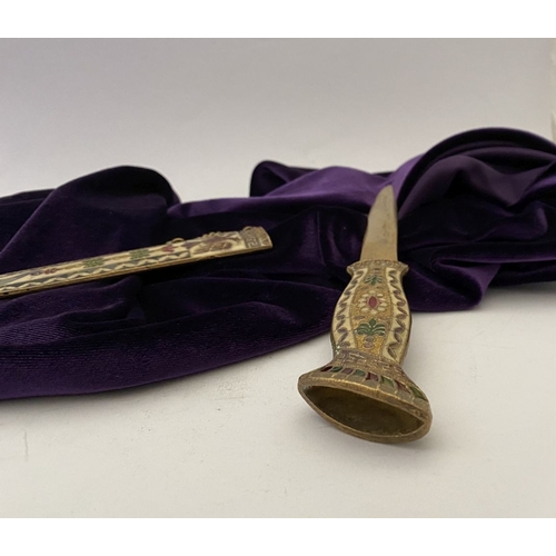 106 - A HIGHLY DECORATIVE BRASS ENAMELLED LETTER OPENER, the cover and handle with vibrantly coloured desi... 