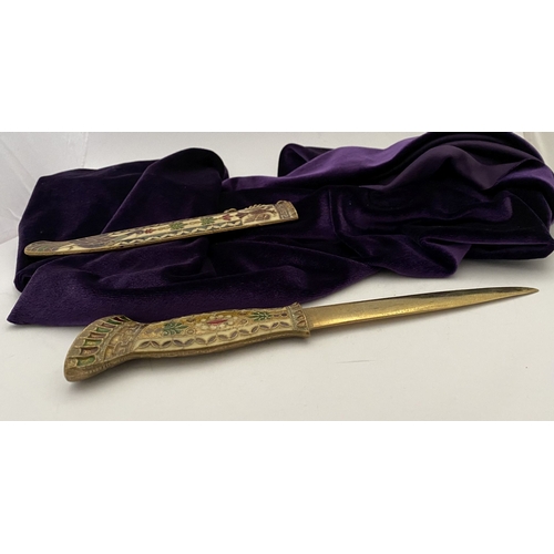 106 - A HIGHLY DECORATIVE BRASS ENAMELLED LETTER OPENER, the cover and handle with vibrantly coloured desi... 