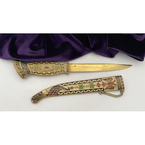 106 - A HIGHLY DECORATIVE BRASS ENAMELLED LETTER OPENER, the cover and handle with vibrantly coloured desi... 