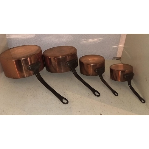 108 - A SET OF FOUR VINTAGE COPPER SAUCEPANS, graduating in size, with tinned interiors. Dimensions: large... 