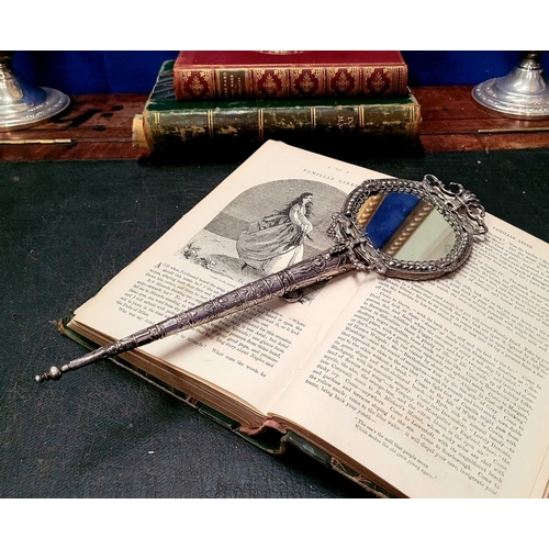 11 - A 19TH CENTURY CONTINENTAL SILVER LADY’S HAND MIRROR, possibly French, the mirror framed with scroll... 