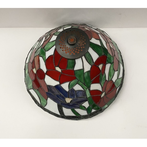 120 - A LARGE TIFFANY STYLE STAINED GLASS LAMPSHADE, floral design in vibrant colours with border to base,... 