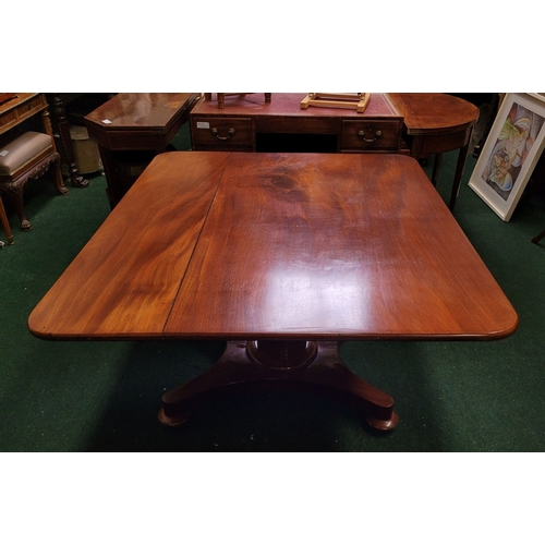 125 - A LARGE IRISH REGENCY MAHOGANY TIP-UP DINING TABLE, the table top made from two pieces of stunning m... 