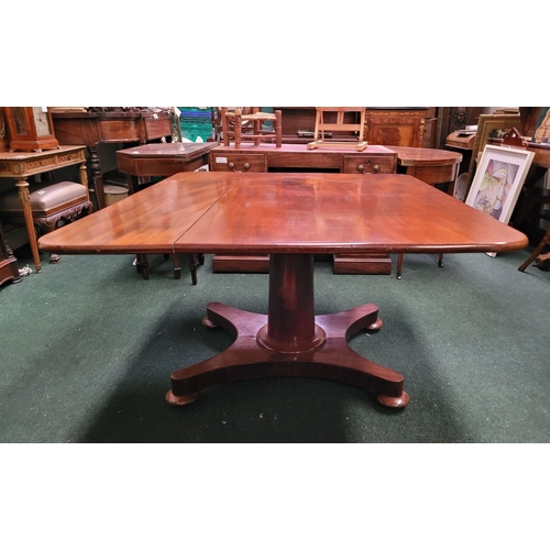 125 - A LARGE IRISH REGENCY MAHOGANY TIP-UP DINING TABLE, the table top made from two pieces of stunning m... 