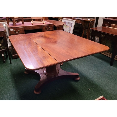 125 - A LARGE IRISH REGENCY MAHOGANY TIP-UP DINING TABLE, the table top made from two pieces of stunning m... 