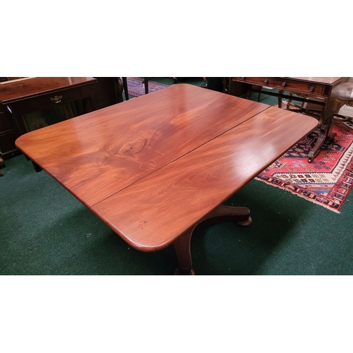 125 - A LARGE IRISH REGENCY MAHOGANY TIP-UP DINING TABLE, the table top made from two pieces of stunning m... 