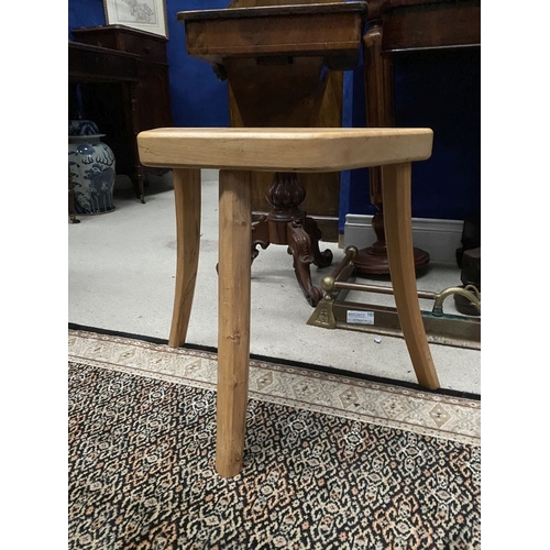 137 - A DON & EAMONN O’SULLIVAN, THREE-LEGGED STOOL, the shaped beech top raised on three carved legs made... 