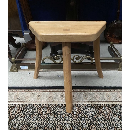 137 - A DON & EAMONN O’SULLIVAN, THREE-LEGGED STOOL, the shaped beech top raised on three carved legs made... 