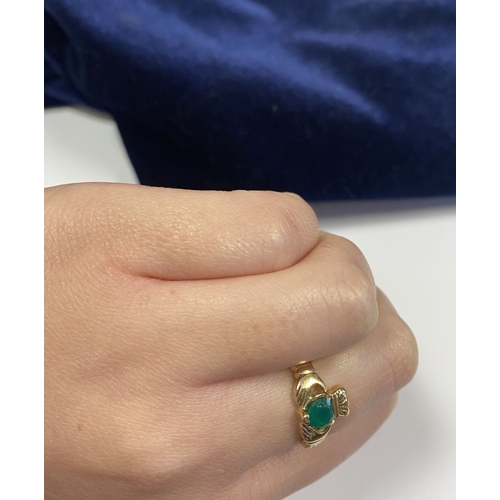 158 - A 10CT YELLOW GOLD GEMSET CLADDAGH RING, the green gemstone set to the centre in a heart shape. Ring... 