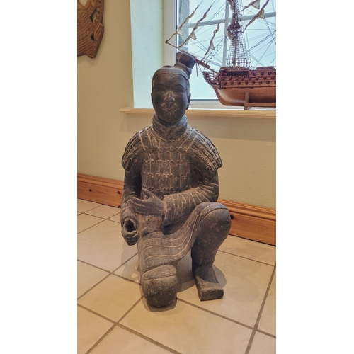 173 - A TERRACOTTA WARRIOR DECORATIVE ORNAMENTAL STATUE, in a knelling position. Dimensions: 67.5 x 32 x 2... 