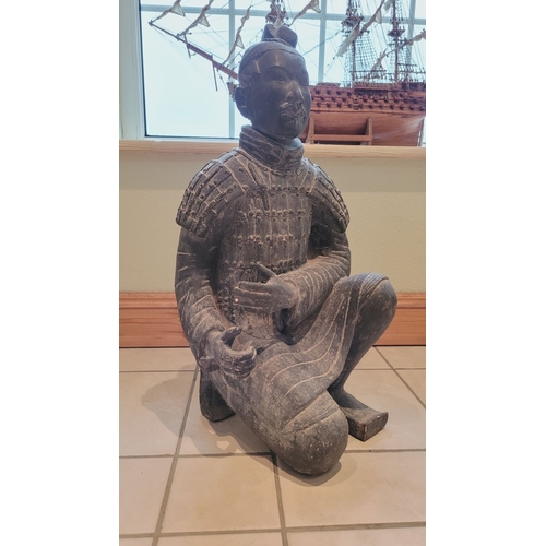 173 - A TERRACOTTA WARRIOR DECORATIVE ORNAMENTAL STATUE, in a knelling position. Dimensions: 67.5 x 32 x 2... 