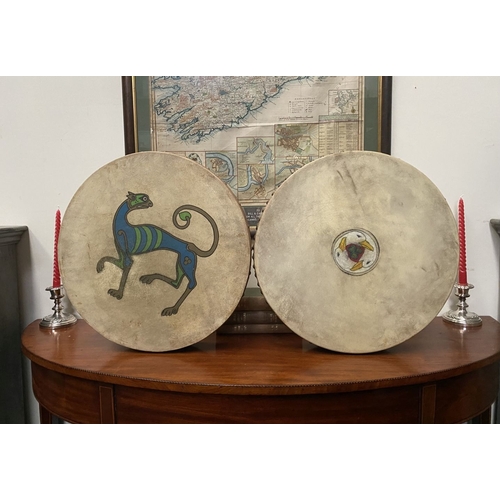 193 - TWO IRISH BODHRAN DRUMS, both with nice Celtic designs, dimensions: 45.5cm & 46.5cm diameter approx.