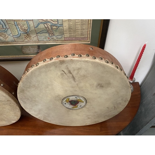 193 - TWO IRISH BODHRAN DRUMS, both with nice Celtic designs, dimensions: 45.5cm & 46.5cm diameter approx.