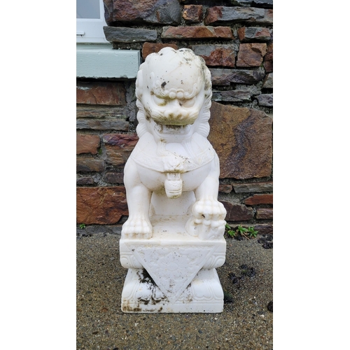 197 - A PAIR OF MARBLE GARDEN ORNAMENTS IN THE FORM OF GUARDIAN LIONS, one male, one female, one with a pa... 