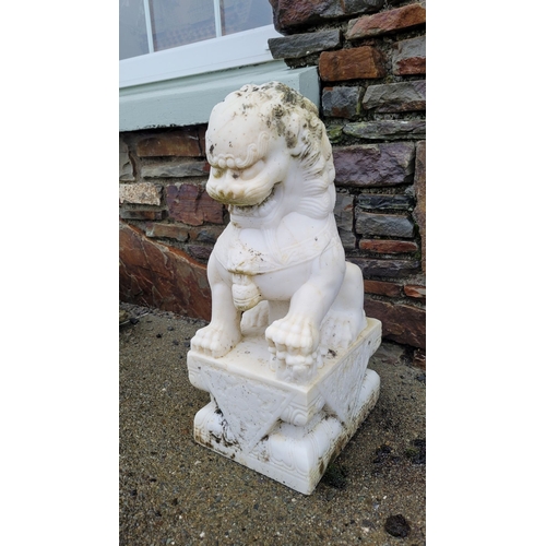 197 - A PAIR OF MARBLE GARDEN ORNAMENTS IN THE FORM OF GUARDIAN LIONS, one male, one female, one with a pa... 