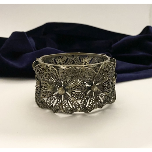 208 - A VINTAGE LARGE BARTEK FILIGREE BANGLE BRACELET, beautiful intricate floral design surrounding in si... 