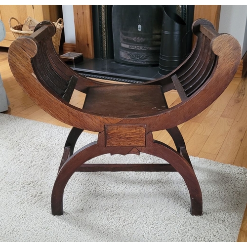 216 - A 19TH CENTURY OAK CURVED WINDOW / PIANO SEAT, with five bar curved elbow rests on each side, raised... 