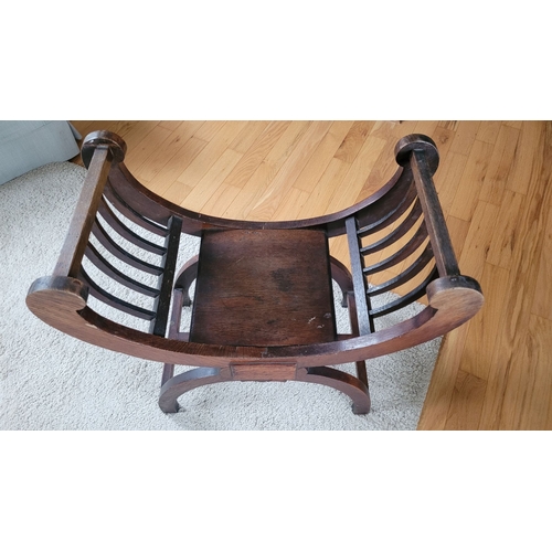 216 - A 19TH CENTURY OAK CURVED WINDOW / PIANO SEAT, with five bar curved elbow rests on each side, raised... 