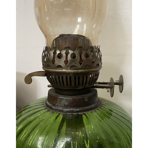 33 - A VICTORIAN GREEN GLASS DOUBLE BURNER OIL LAMP, complete with glass chimney, the double burners read... 