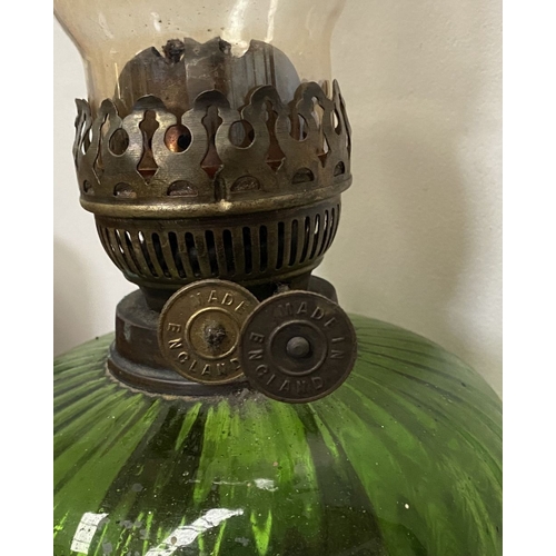 33 - A VICTORIAN GREEN GLASS DOUBLE BURNER OIL LAMP, complete with glass chimney, the double burners read... 