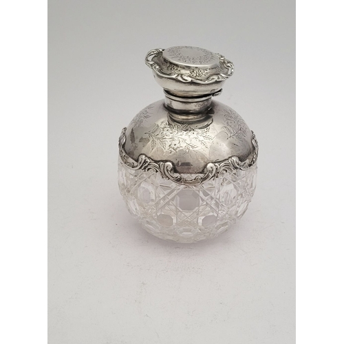 35 - A LOVELY EARLY 20TH CENTURY SILVER TOPPED CUT GLASS SCENT BOTTLE, the lid, and shoulders capped with... 