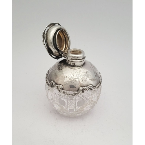 35 - A LOVELY EARLY 20TH CENTURY SILVER TOPPED CUT GLASS SCENT BOTTLE, the lid, and shoulders capped with... 