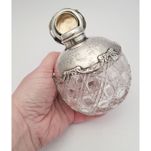 35 - A LOVELY EARLY 20TH CENTURY SILVER TOPPED CUT GLASS SCENT BOTTLE, the lid, and shoulders capped with... 