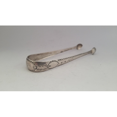 39 - A GOOD IRISH LATE 18TH CENTURY SILVER SUGAR TONGS, circa 1795, with bright cut decoration to the ste... 