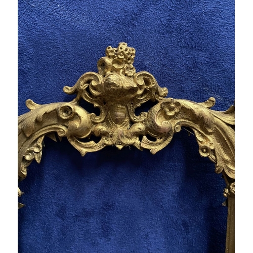 64 - A 19TH CENTURY ORNATE GILT BRONZE FRAME, neo classical with cherub mounts to sides, scrolling crest ... 