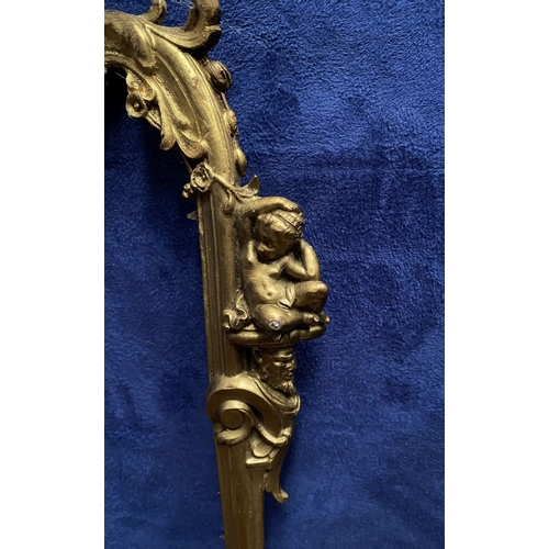 64 - A 19TH CENTURY ORNATE GILT BRONZE FRAME, neo classical with cherub mounts to sides, scrolling crest ... 