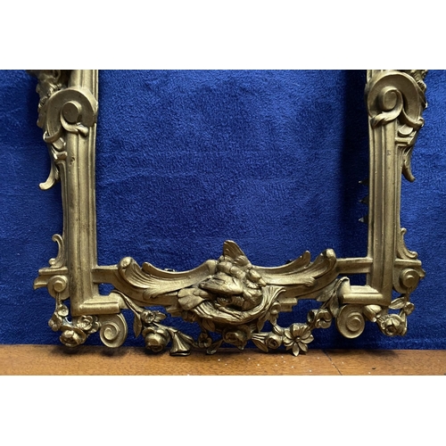 64 - A 19TH CENTURY ORNATE GILT BRONZE FRAME, neo classical with cherub mounts to sides, scrolling crest ... 