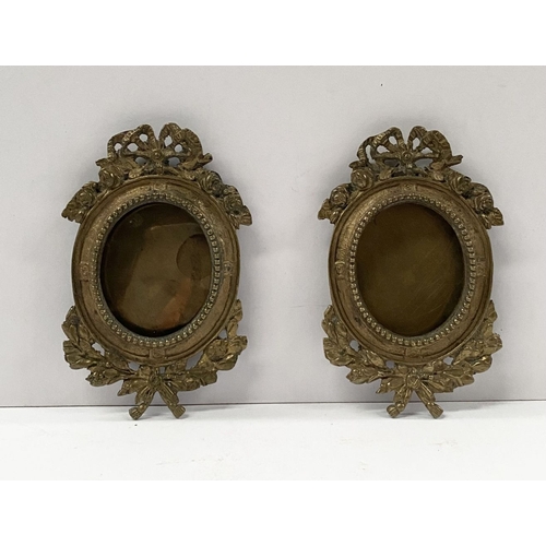 81 - A PAIR OF LATE 19TH CENTURY ORNATE BRASS MINIATURE PAINTING FRAMES, oval frame surrounded by beaded ... 