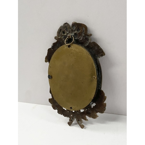 81 - A PAIR OF LATE 19TH CENTURY ORNATE BRASS MINIATURE PAINTING FRAMES, oval frame surrounded by beaded ... 