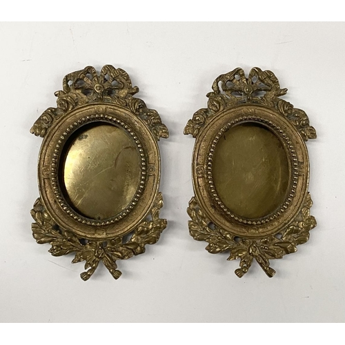 81 - A PAIR OF LATE 19TH CENTURY ORNATE BRASS MINIATURE PAINTING FRAMES, oval frame surrounded by beaded ... 