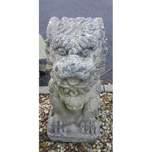 92 - A LARGE PAIR OF COMPOSITE GARDEN ORNAMENTS, in the form of Foo Dogs, detailed and very heavy, wear a... 