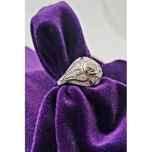 10 - A STUNNING 18CT WHITE GOLD DIAMOND BOMBÉ COCKTAIL RING, with a central round cut diamond surrounded ... 