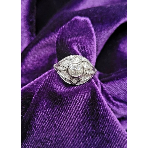 10 - A STUNNING 18CT WHITE GOLD DIAMOND BOMBÉ COCKTAIL RING, with a central round cut diamond surrounded ... 