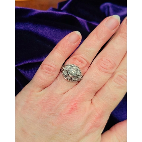 10 - A STUNNING 18CT WHITE GOLD DIAMOND BOMBÉ COCKTAIL RING, with a central round cut diamond surrounded ... 