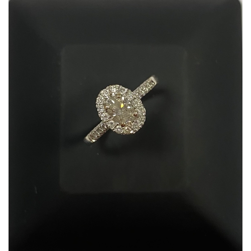 80 - A BEAUTIFUL 14CT WHITE GOLD DIAMOND CLUSTER RING, with central oval brilliant cut diamond, weight: .... 