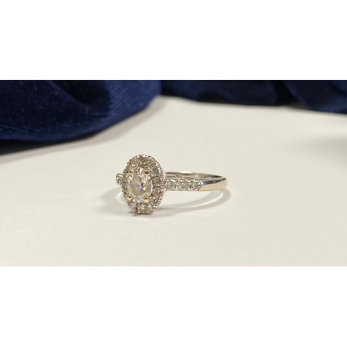 80 - A BEAUTIFUL 14CT WHITE GOLD DIAMOND CLUSTER RING, with central oval brilliant cut diamond, weight: .... 