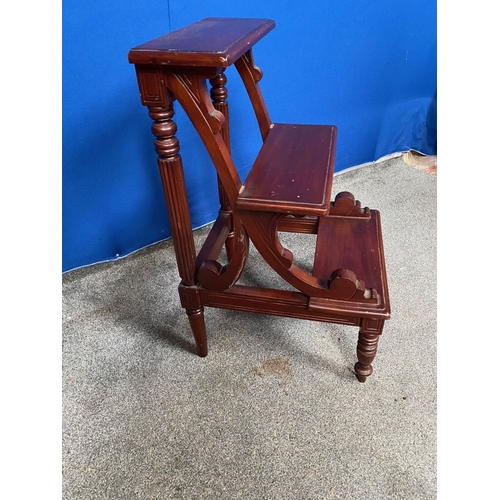 128 - AN UNUSUAL MAHOGANY THREE STEP LIBRARY LADDER, raised on turned & reed decorated legs to the back, w... 