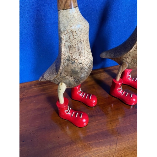 201 - TWO PAINTED WOODEN ORNAMENTS IN THE FORM OF DUCKS, both wearing red boots. Quirky decorative pair. E... 