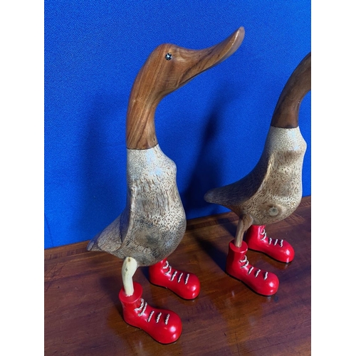 201 - TWO PAINTED WOODEN ORNAMENTS IN THE FORM OF DUCKS, both wearing red boots. Quirky decorative pair. E... 