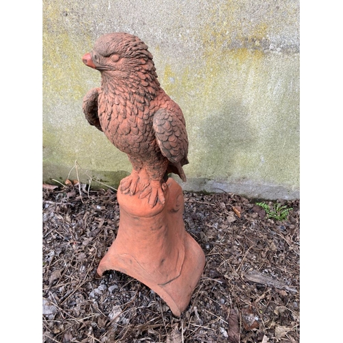 278 - A GARDEN ORNAMENT IN THE FORM OF A HAWK, standing upon a platform base with curved support. 59cm tal... 