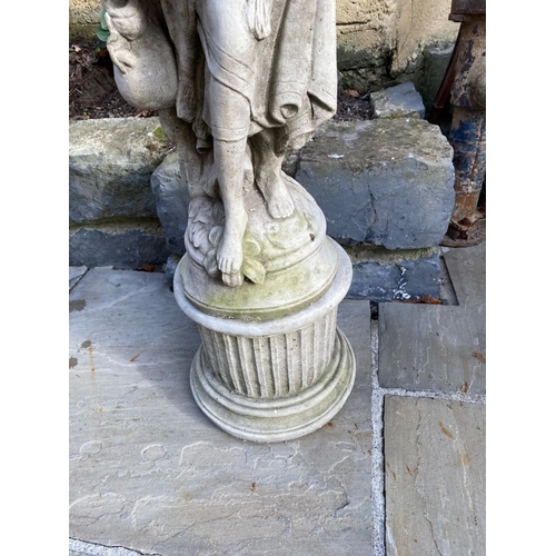 283 - A NICE GARDEN ORNAMENT IN THE FORM OF A FEMALE FIGURE, she stands upon a raised column base. Dimensi... 