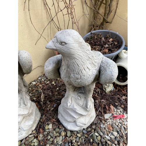 285 - TWO GARDEN ORNAMENTS IN THE FORM OF EAGLES STANDING ON ROCK SHAPED BASES, 60cm tall each.