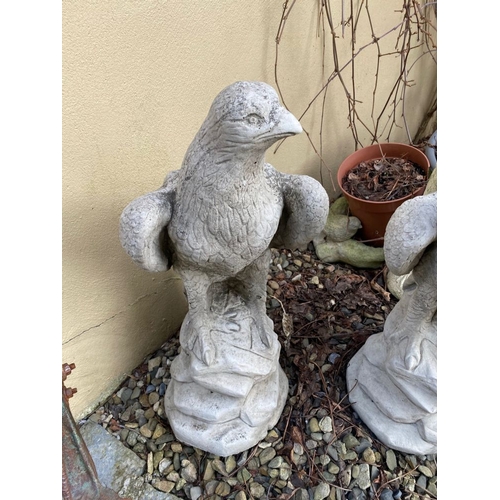 285 - TWO GARDEN ORNAMENTS IN THE FORM OF EAGLES STANDING ON ROCK SHAPED BASES, 60cm tall each.